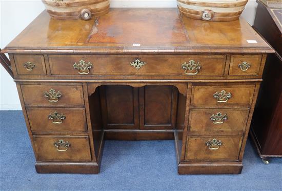 A Georgian style walnut kneehole desk W.120cm